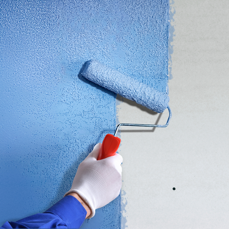 Applying Sika Blue Grit bonding agent with a roller